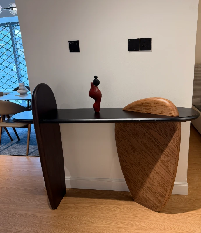 Contemporary console table with sculptural wooden base for modern interiors